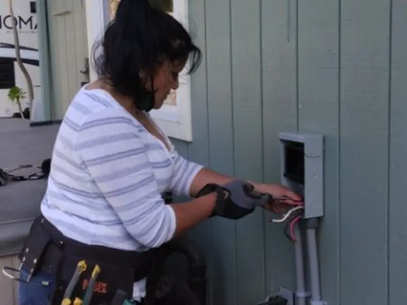 Licensed electrician wiring an exterior subpanel in Liberty Lake